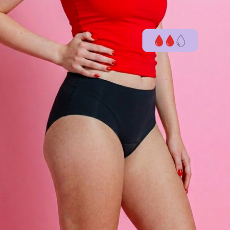 Person show side on wearing a red top and black period underwear on a pink background with absorbency drop icons.