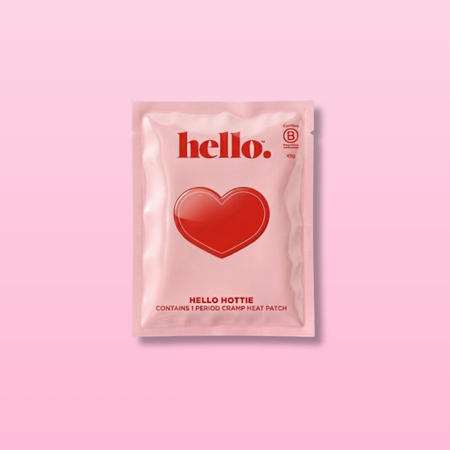 Pink packaging of Hello Hottie heat patch with a red heart on a pink background