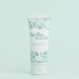 A tube of Hello Wash menstrual cup and menstrual disc cleaner with a floral pattern on a light background.