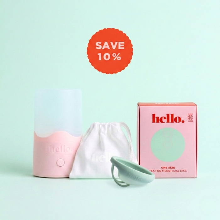 Menstrual disc in sea fog with packaging and discount label on a light green background