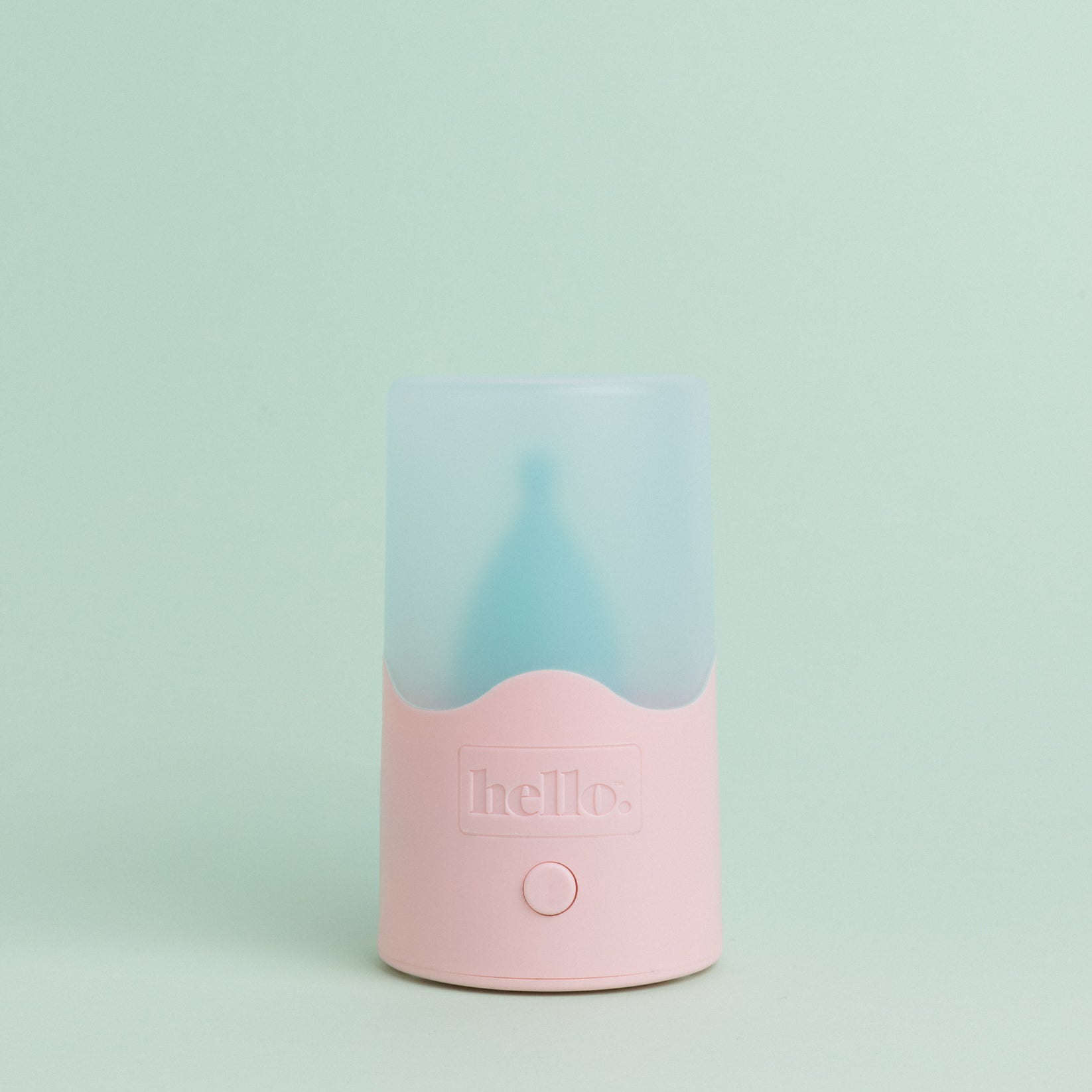 Steam steriliser with pink base and frosted blue lid against a pastel green background 